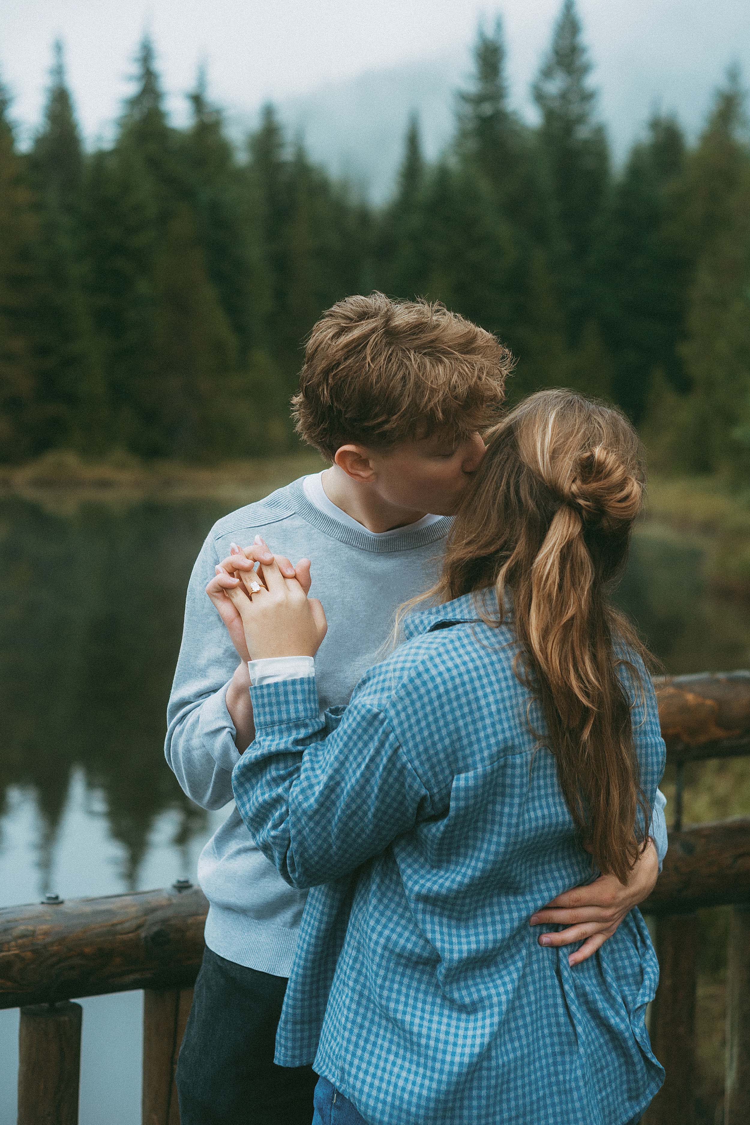 Love story photography — Engaged couple embracing on the dock at trillium lake mount hood oregon